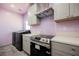 Well-equipped kitchen featuring modern appliances, light gray cabinetry and sleek countertops at 2807 Hermosa St, Las Vegas, NV 89169