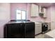 New kitchen featuring modern washer dryer, stainless steel appliances, stylish cabinets and countertops at 2807 Hermosa St, Las Vegas, NV 89169