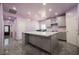 Spacious kitchen showcasing an oversized island, stainless steel appliances, and unique gray marble flooring at 2807 Hermosa St, Las Vegas, NV 89169