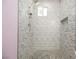 Glass enclosed tiled shower featuring rain shower head, built in niche, and neutral color palette at 2807 Hermosa St, Las Vegas, NV 89169