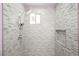 Glass enclosed tiled shower featuring rain shower head, built in niche, and neutral color palette at 2807 Hermosa St, Las Vegas, NV 89169