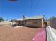 Rear exterior view of the house featuring a covered patio, windows, and gravel landscaping at 2921 Mitzi Ave, Las Vegas, NV 89101