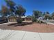 Charming single-story home featuring mature trees and low-maintenance desert landscaping in the front yard at 2921 Mitzi Ave, Las Vegas, NV 89101