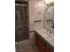 Bathroom featuring tiled walls, glass shower door, and a vanity with ample storage, offering a clean aesthetic at 3111 Bel Air Dr # 6E, Las Vegas, NV 89109