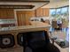 Open concept kitchen and dining area filled with natural light, featuring wood cabinets and a breakfast bar at 3111 Bel Air Dr # 6E, Las Vegas, NV 89109