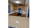 Traditional kitchen featuring wood cabinets, stainless steel appliances, and tiled countertops, providing functionality and style at 3111 Bel Air Dr # 6E, Las Vegas, NV 89109