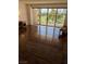 Bright living room showcasing hardwood floors and a sliding glass door with views of the golf course and city skyline at 3111 Bel Air Dr # 6E, Las Vegas, NV 89109