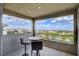 Relax on this covered balcony with ample seating and enjoy stunning views of the surrounding landscape and beautiful blue skies at 350 Gandara St, Las Vegas, NV 89138