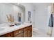 Bright bathroom featuring a double sink vanity, white marble countertop, a shower, and modern decor at 350 Gandara St, Las Vegas, NV 89138