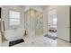 Bathroom features a soaking tub, glass shower, and marble tile floors at 350 Gandara St, Las Vegas, NV 89138