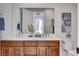 Elegant bathroom with double sinks, marble countertop, wood cabinets, and contemporary fixtures at 350 Gandara St, Las Vegas, NV 89138