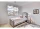 Cozy bedroom with a twin bed, a large window, plush pillows, and a cute bunny rug at 350 Gandara St, Las Vegas, NV 89138