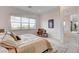 Inviting bedroom with a plush bed, window views, and a comfortable chair in the corner at 350 Gandara St, Las Vegas, NV 89138