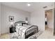 Modern bedroom with a stylish metal bed, plush rug, neutral decor, and easy access to an ensuite bath at 350 Gandara St, Las Vegas, NV 89138