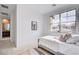 Comfortable bedroom featuring a twin bed, a large window, and view to an ensuite bathroom at 350 Gandara St, Las Vegas, NV 89138