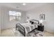 Stylish bedroom with a black metal bed frame, soft bedding, and views from the large window at 350 Gandara St, Las Vegas, NV 89138