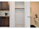 Open hall closet between a dark cabinet vanity and a powder room with white sink and toilet at 350 Gandara St, Las Vegas, NV 89138
