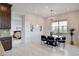 Sunlit dining area adjacent to kitchen, perfect for entertaining with an elegant chandelier at 350 Gandara St, Las Vegas, NV 89138