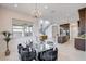 Open dining area connecting kitchen and living room with stylish chandelier and black chairs at 350 Gandara St, Las Vegas, NV 89138