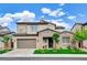 Charming two-story home featuring a stone facade, desert landscaping, and a spacious two-car garage at 350 Gandara St, Las Vegas, NV 89138
