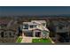 Charming two-story home with a stone facade, well-manicured lawn, and an attached two-car garage with mountain views in the distance at 350 Gandara St, Las Vegas, NV 89138