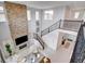 Aerial view of the great room, featuring a stone fireplace, stairs to the loft, and large windows at 350 Gandara St, Las Vegas, NV 89138