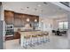 Open kitchen featuring granite countertops, a large island with barstool seating, and a view of the adjacent dining area at 350 Gandara St, Las Vegas, NV 89138