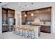Gourmet kitchen with granite countertops, stainless steel appliances, a large island, and stylish bar stools at 350 Gandara St, Las Vegas, NV 89138