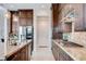 Gourmet kitchen featuring sleek stainless steel appliances, a spacious island, and ample cabinet space at 350 Gandara St, Las Vegas, NV 89138