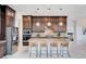 Modern kitchen with granite countertops, stainless steel appliances, pendant lighting, and barstool seating at the island at 350 Gandara St, Las Vegas, NV 89138