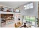 Open-concept living space featuring a staircase, balcony, an adjacent kitchen, and sliding glass doors to the backyard at 350 Gandara St, Las Vegas, NV 89138