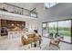 Living room overlooking a manicured backyard, with access to the patio through sliding glass doors and an open-concept kitchen at 350 Gandara St, Las Vegas, NV 89138