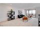 Bright living room featuring modern decor, a black sofa, and a sliding glass door to an outdoor balcony at 350 Gandara St, Las Vegas, NV 89138