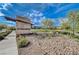 Monument signage for 'Acadia Ridge' is nestled in a desert landscape of rocks and drought-tolerant plants, adding a touch of elegance at 350 Gandara St, Las Vegas, NV 89138