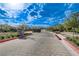 Experience the inviting community entrance lined with trees, stone details, and lush landscaping, creating a serene welcome at 350 Gandara St, Las Vegas, NV 89138
