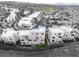 Aerial view of modern home with a golf course and community in the background at 358 Solitude Peak Ln, Henderson, NV 89012