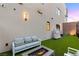 Modern backyard features outdoor seating and a small grass area with perimeter fencing at 358 Solitude Peak Ln, Henderson, NV 89012