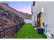 Modern backyard features a small grass area and perimeter fencing at 358 Solitude Peak Ln, Henderson, NV 89012