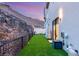 Modern backyard features a small grass area and perimeter fencing at 358 Solitude Peak Ln, Henderson, NV 89012