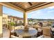 Relaxing balcony features a dining table, chairs, and views of the surrounding neighborhood at 358 Solitude Peak Ln, Henderson, NV 89012
