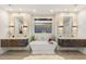 Luxurious bathroom featuring double vanities, soaking tub, and a window with a view at 358 Solitude Peak Ln, Henderson, NV 89012