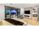 Luxurious bedroom featuring a fireplace, balcony, and views of the city skyline at 358 Solitude Peak Ln, Henderson, NV 89012