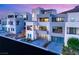 Modern home exterior with multi-car garage, desert landscaping, and balconies at 358 Solitude Peak Ln, Henderson, NV 89012