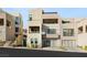 Contemporary home with multiple balconies, desert landscaping, and multi-car garage at 358 Solitude Peak Ln, Henderson, NV 89012