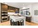 Modern kitchen featuring custom cabinets, a large island with seating, and stainless steel appliances at 358 Solitude Peak Ln, Henderson, NV 89012