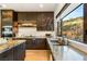 Bright, modern kitchen with stainless steel appliances, custom cabinetry, and a large window with natural views at 358 Solitude Peak Ln, Henderson, NV 89012