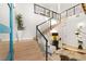 Grand foyer with open staircase, glass railings, and stylish decor at 358 Solitude Peak Ln, Henderson, NV 89012