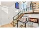 Staircase with wooden steps, glass railing, and plenty of natural light from large windows at 358 Solitude Peak Ln, Henderson, NV 89012