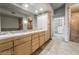 Bright bathroom boasting double sinks, large mirror, and a walk-in shower at 360 E Desert Inn Rd # 807, Las Vegas, NV 89109