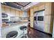 Modern kitchen with stainless steel appliances, light wood cabinetry, granite countertops, and a center island at 360 E Desert Inn Rd # 807, Las Vegas, NV 89109